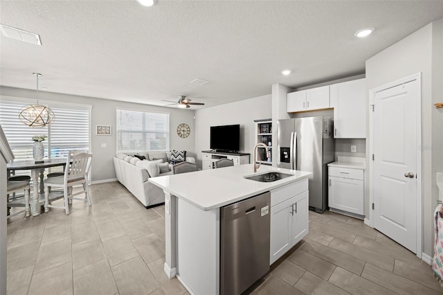 2760 Scarlet Bay Pl, Brandon, FL 33510 - kitchen featuring a sink, appliances with stainless steel finishes, light countertops, and white cabinetry