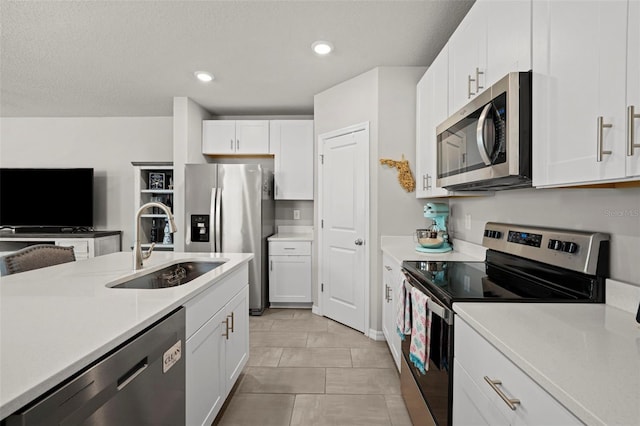 2760 Scarlet Bay Pl, Brandon, FL 33510 - kitchen featuring a sink, stainless steel appliances, white cabinetry, and light countertops