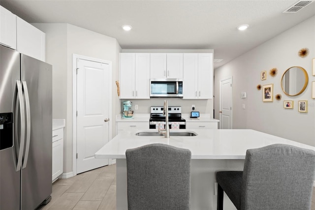 2760 Scarlet Bay Pl, Brandon, FL 33510 - kitchen with visible vents, recessed lighting, stainless steel appliances, light countertops, and white cabinetry