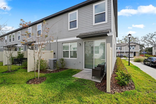 2760 Scarlet Bay Pl, Brandon, FL 33510 - back of property with a yard, stucco siding, central AC, and fence