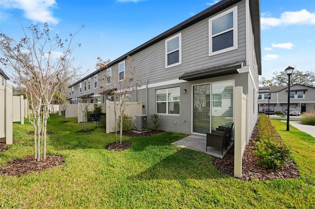 2760 Scarlet Bay Pl, Brandon, FL 33510 - rear view of house featuring stucco siding, a residential view, a lawn, and fence