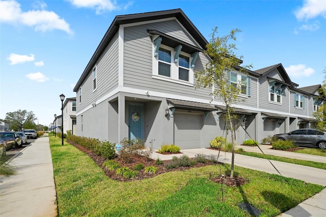 2760 Scarlet Bay Pl, Brandon, FL 33510 - multi unit property featuring stucco siding, driveway, a residential view, an attached garage, and a front yard