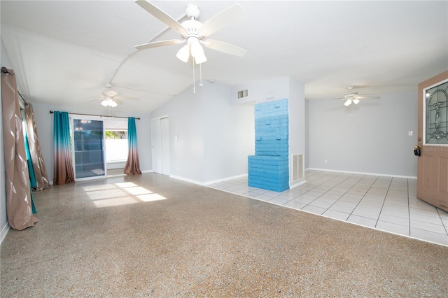 unfurnished living room featuring a ceiling fan, tile patterned floors, vaulted ceiling, and visible vents