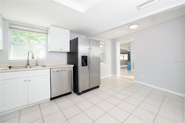 kitchen featuring light countertops, visible vents, white cabinets, stainless steel appliances, and a sink