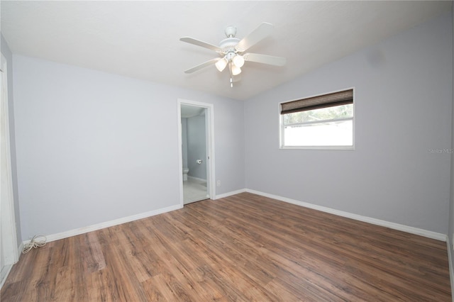 unfurnished room featuring baseboards, wood finished floors, and ceiling fan
