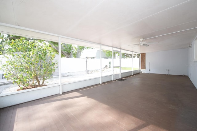 unfurnished sunroom featuring ceiling fan