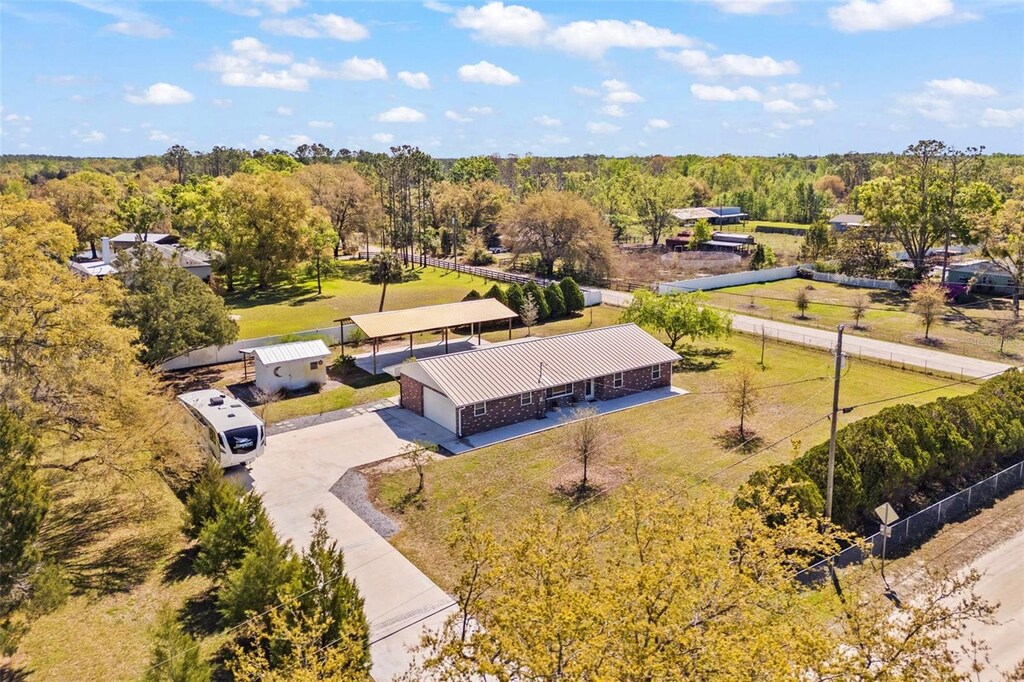drone / aerial view featuring a wooded view
