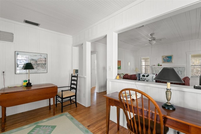 office area featuring visible vents, wood finished floors, and a ceiling fan