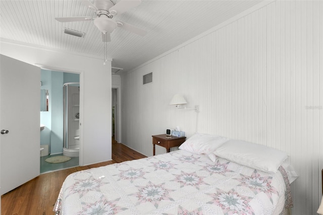 bedroom featuring connected bathroom, visible vents, ceiling fan, and wood finished floors