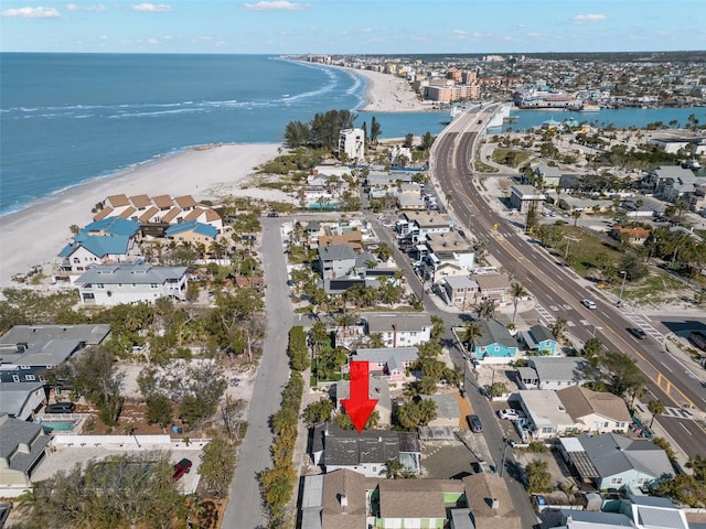 drone / aerial view with a water view and a beach view