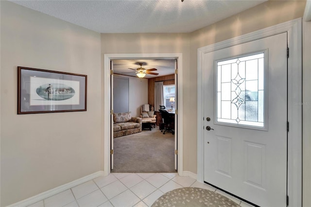 2007 E View Dr, Sun City Center, FL 33573 - entryway with light tile patterned flooring, baseboards, a wealth of natural light, and a textured ceiling