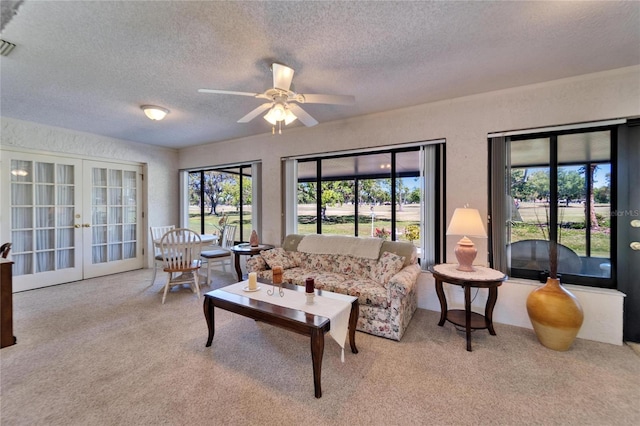 2007 E View Dr, Sun City Center, FL 33573 - carpeted living area featuring french doors, a textured ceiling, a ceiling fan, and a textured wall