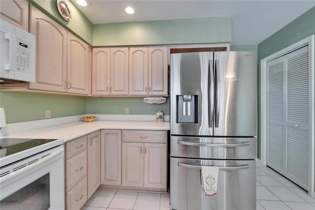 2007 E View Dr, Sun City Center, FL 33573 - kitchen featuring white appliances, light tile patterned floors, light countertops, and light brown cabinetry