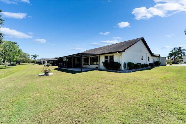2007 E View Dr, Sun City Center, FL 33573 - back of property featuring stucco siding, a patio, and a yard