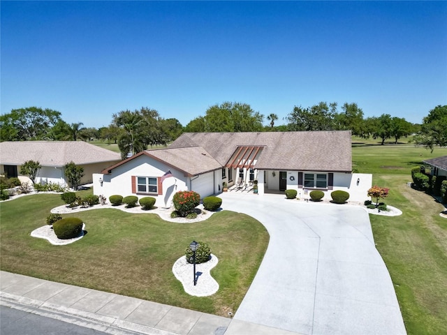 2007 E View Dr, Sun City Center, FL 33573 - single story home with concrete driveway, a garage, a front yard, and stucco siding