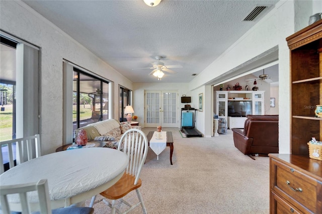 2007 E View Dr, Sun City Center, FL 33573 - dining space with visible vents, carpet, ceiling fan, french doors, and a textured ceiling