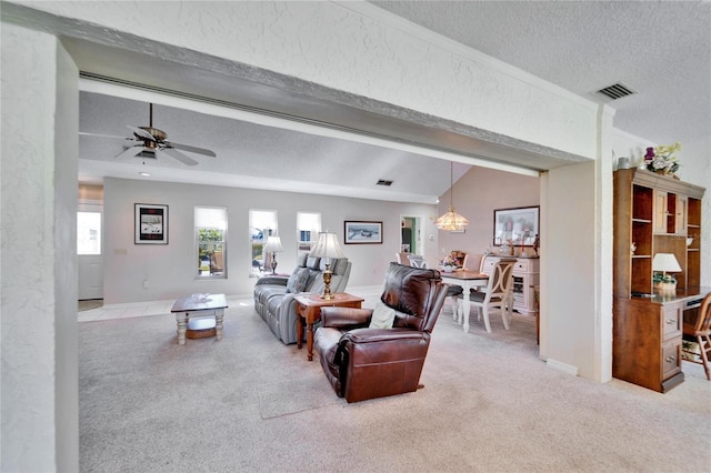 2007 E View Dr, Sun City Center, FL 33573 - living room featuring a ceiling fan, visible vents, lofted ceiling with beams, a textured ceiling, and light colored carpet
