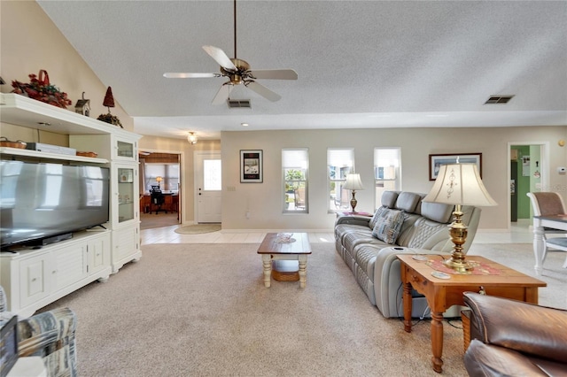 2007 E View Dr, Sun City Center, FL 33573 - living room featuring light carpet, visible vents, a textured ceiling, and a ceiling fan