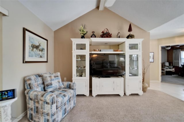 2007 E View Dr, Sun City Center, FL 33573 - living area with baseboards, carpet flooring, vaulted ceiling with beams, and ceiling fan