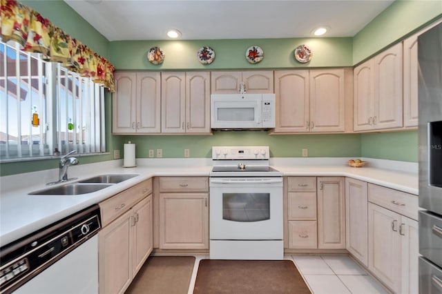 2007 E View Dr, Sun City Center, FL 33573 - kitchen featuring light brown cabinets, light tile patterned floors, white appliances, and a sink