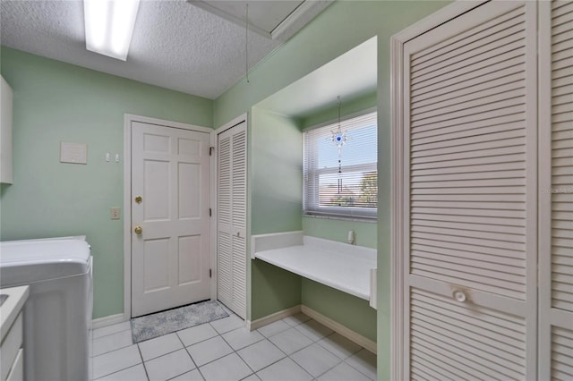 2007 E View Dr, Sun City Center, FL 33573 - clothes washing area with attic access, light tile patterned floors, laundry area, washer / dryer, and a textured ceiling