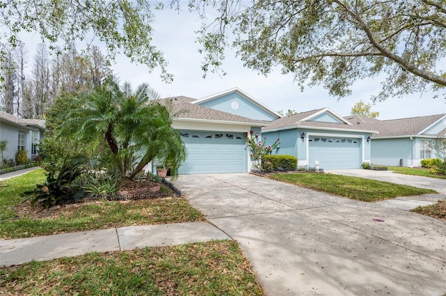 view of front of home with stucco siding, a garage, and concrete driveway