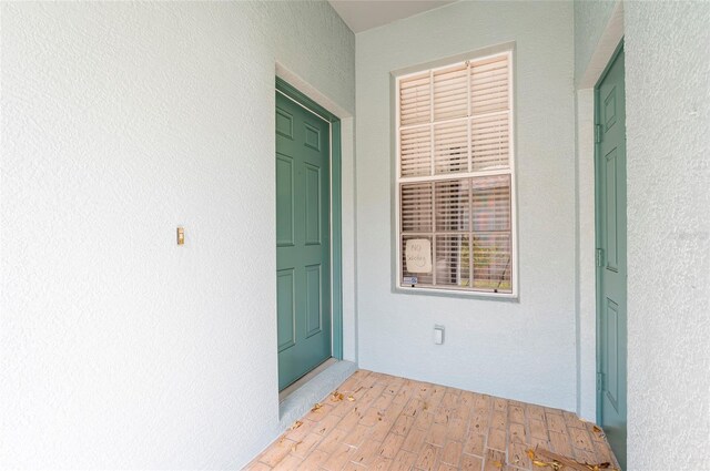 doorway to property with stucco siding