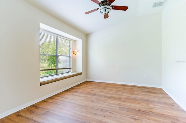 unfurnished room with baseboards, visible vents, light wood-style floors, and a ceiling fan