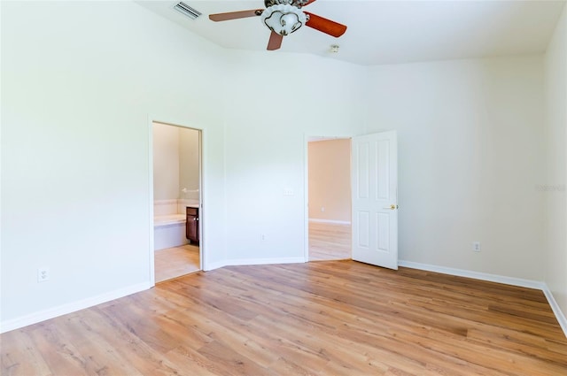empty room with baseboards, light wood-style flooring, visible vents, and a ceiling fan