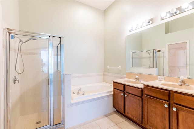 full bath with a shower stall, tile patterned flooring, a sink, and a garden tub