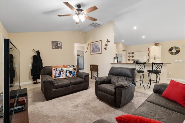 living area featuring vaulted ceiling, baseboards, visible vents, and ceiling fan