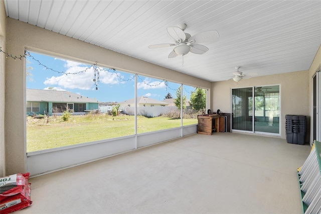 sunroom / solarium with a ceiling fan