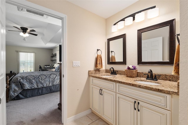 bathroom with a sink, double vanity, a ceiling fan, and connected bathroom