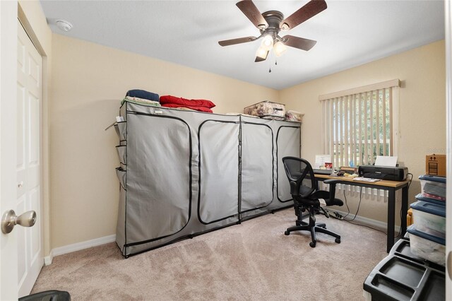 carpeted office with baseboards and ceiling fan