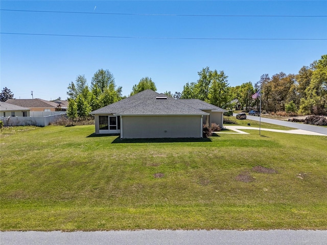 view of side of home with a lawn