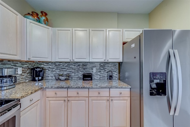 19829 Gulf Blvd Unit 601, Indian Shores, FL 33785 - kitchen featuring tasteful backsplash, white cabinets, stainless steel appliances, and light stone counters