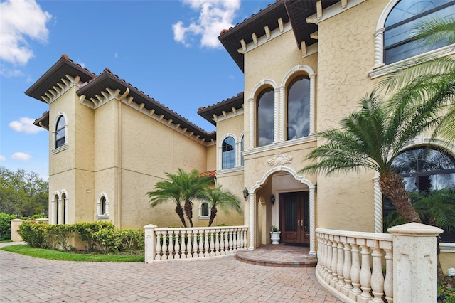 view of front facade featuring french doors and stucco siding