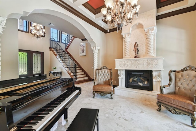 living area featuring coffered ceiling, a high end fireplace, french doors, arched walkways, and a chandelier