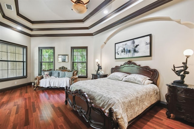 bedroom featuring visible vents, ornamental molding, baseboards, and wood finished floors