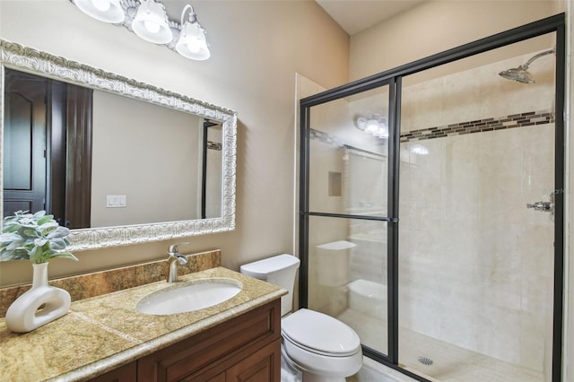 full bathroom with vanity, toilet, and a stall shower