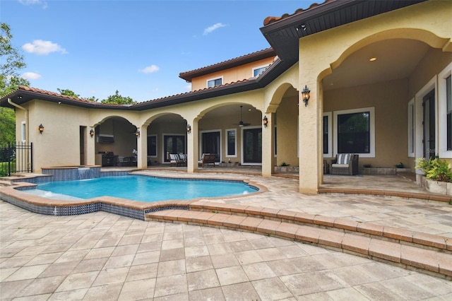 outdoor pool featuring ceiling fan and a patio