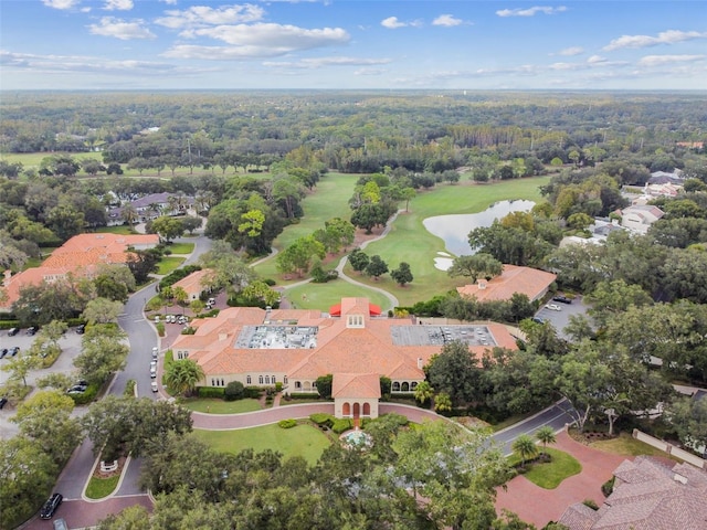 aerial view with a view of trees, a water view, and view of golf course
