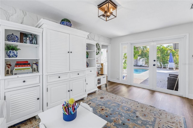 interior space featuring baseboards, dark wood-style floors, visible vents, and french doors