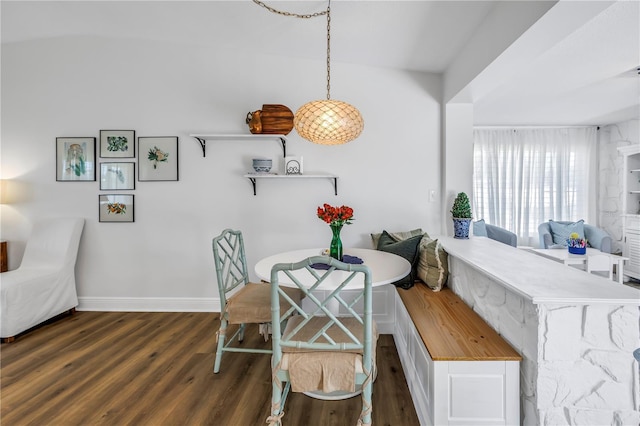 dining space featuring baseboards, wood finished floors, and breakfast area