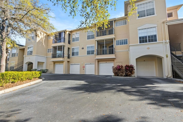view of property featuring an attached garage and driveway