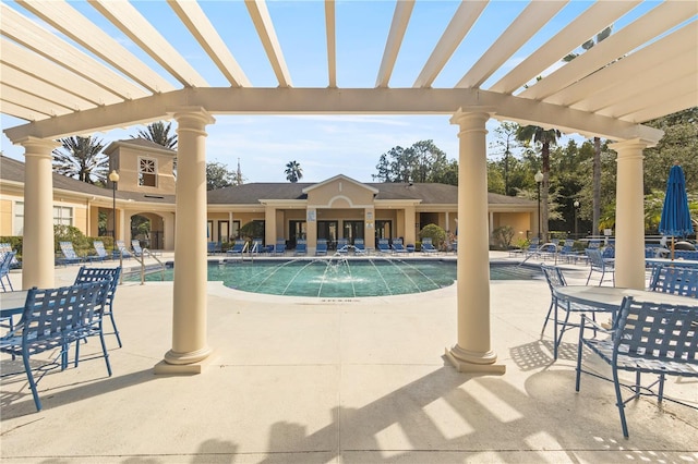 pool with a patio area and a pergola