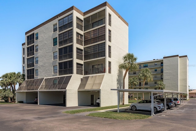 9860 62nd Ter N Unit 1051, Saint Petersburg, FL 33708 - view of property featuring covered parking