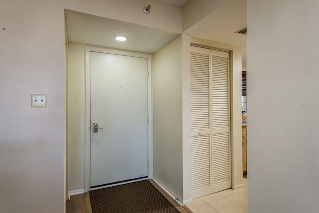 9860 62nd Ter N Unit 1051, Saint Petersburg, FL 33708 - doorway with light tile patterned floors, baseboards, and visible vents