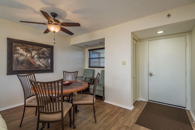 9860 62nd Ter N Unit 1051, Saint Petersburg, FL 33708 - dining area featuring wood finished floors, baseboards, ceiling fan, and a textured ceiling