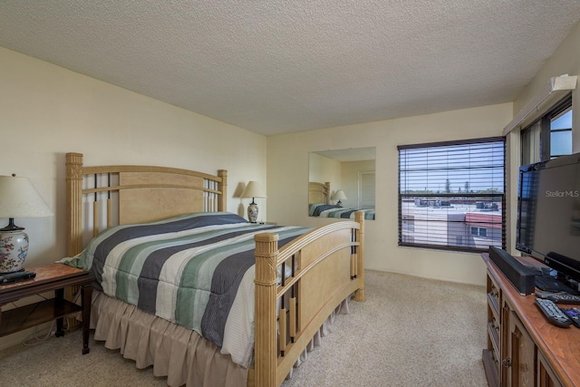 9860 62nd Ter N Unit 1051, Saint Petersburg, FL 33708 - bedroom featuring a textured ceiling and light colored carpet
